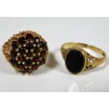 A 9ct gold garnet cluster ring an 9ct gold onyx si