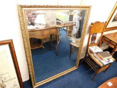 A large modern gilt framed mirror