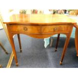 An antique mahogany serpentine front hall table wi