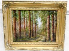 A gilt framed M. Hall oil painting of woodland sce