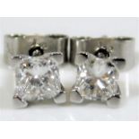 An 18ct gold pair of diamond earrings each set wit