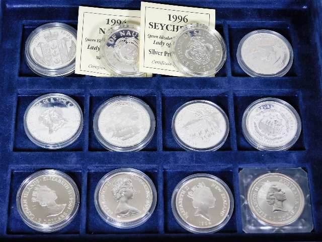 A cased quantity of 12 silver proof crowns, mostly