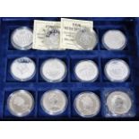 A cased quantity of 12 silver proof crowns, mostly