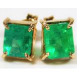 A pair of Colombian yellow metal emerald earrings
