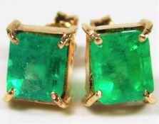 A pair of Colombian yellow metal emerald earrings