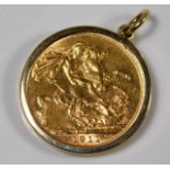 A George V 1911 full gold sovereign within 9ct gold holder approx. 9.3g