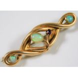 A 15ct gold brooch of organic form set with three