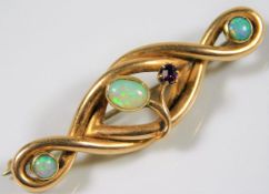 A 15ct gold brooch of organic form set with three