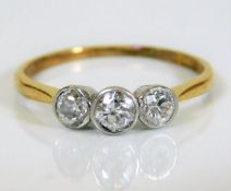 An 18ct gold art deco style ring set with three di
