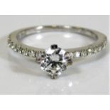 An 18ct white gold diamond ring set with a fine approx. 0.7ct centre diamond of F colour supported b