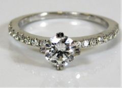 An 18ct white gold diamond ring set with a fine approx. 0.7ct centre diamond of F colour supported b