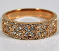 A French 18ct pink gold ring profusely set with di