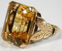 A large yellow metal cocktail ring with organic sh