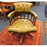 A green leather button back captain's swivel chair