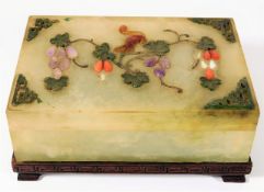 A 19thC. Chinese jade box mounted on hardwood stan
