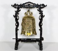 A 19thC. Chinese brass bell set on naturalistic ca