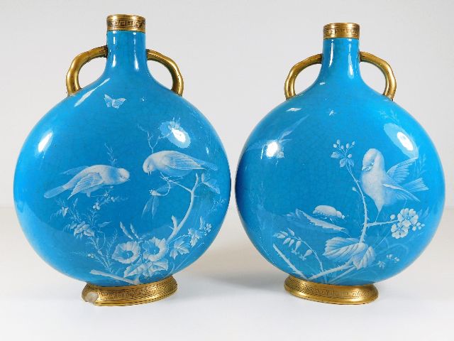 A pair of c.1900 Minton pate sur pate moon flasks