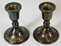 A small pair of sterling silver candleholders