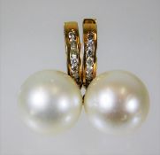 A pair of 18ct gold mounted 12mm pearl earrings se