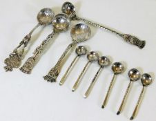 A selection of silver spoons with silver coin bowl