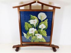 A stylishly designed firescreen with white calla l