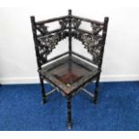 A 19thC. Chinese hardwood corner chair, carved with bamboo & leaves. Provenance: Brought back from H