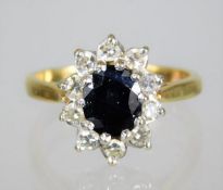 An 18ct gold diamond & sapphire ring, approx. 0.6c