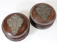 A pair of stained walnut containers with silver cr