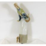 A Lladro figurine with dog & basket 10.75in high