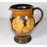 A mid 20thC. Moorcroft pottery leaf & berry jug in autumnal colourway 7in tall
