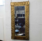 A 19thC. gilt hall mirror with coats of arms to ea