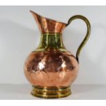 A Victorian copper & brass jug 13in high