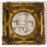 A gilt framed plaque with heavy relief decor 11.62