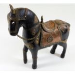A carved Asian horse decorated with copper & brass