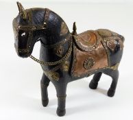 A carved Asian horse decorated with copper & brass