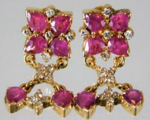 A good pair of 18ct gold earrings set with Burma r