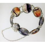 A good quality white metal, tests as silver, bracelet with chased decor to clasp set with blue john