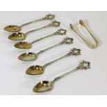 A set of six teaspoons with an added set of tongs