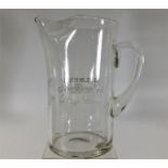 A Gilbey's Dry Gin glass water jug with polished o