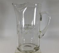A Gilbey's Dry Gin glass water jug with polished o