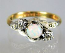 An 18ct gold art deco ring set with opal & diamond