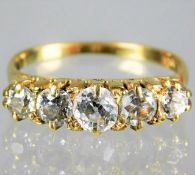 An 18ct gold ring set with five diamonds of approx