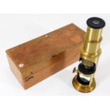 A brass field microscope with box