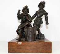 A 19thC. bronze mounted on oak plinth depicting tw