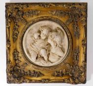 A gilt framed plaque with heavy relief decor, indi
