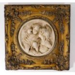 A gilt framed plaque with heavy relief decor, indi