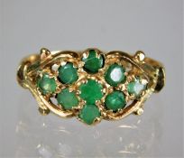 A 9ct gold ring set with emeralds 2g size M