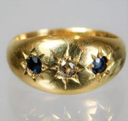 An 18ct gold gypsy style ring set with diamond & s