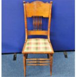 An Edwardian arts & crafts style chair with uphols