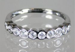 An 18ct gold half eternity ring set with 0.5ct dia